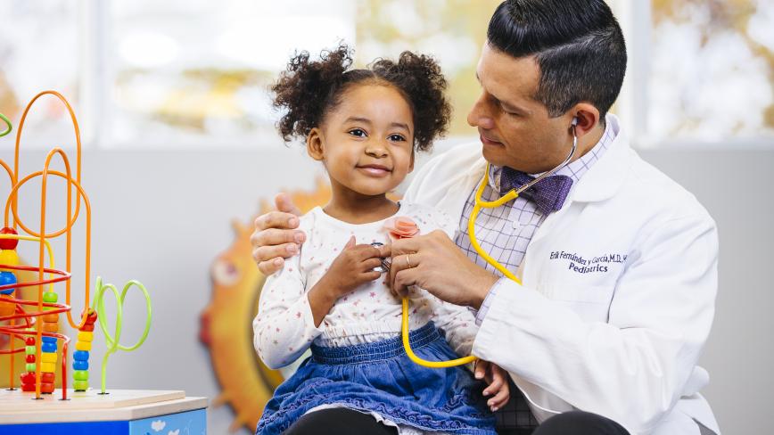 Child sitting on a doctors lap