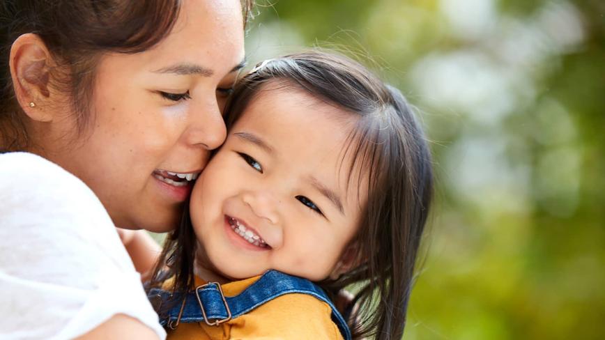 Mother and daughter smiling