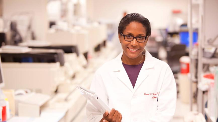 Smiling woman in lab coat