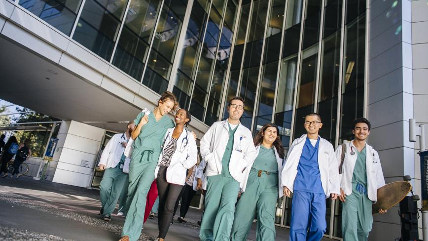 University of California health professional students walking in a group outside of a medical facility