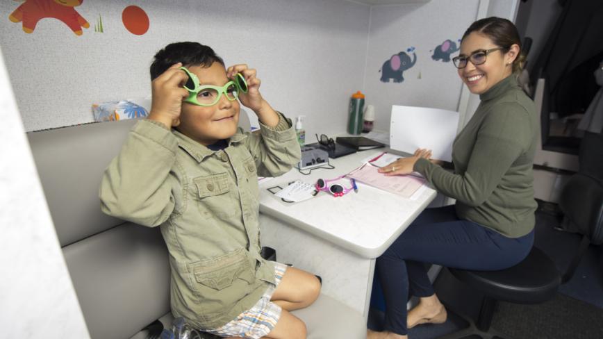 child receiving glasses at UCI Heatlh's Eye Mobile Van