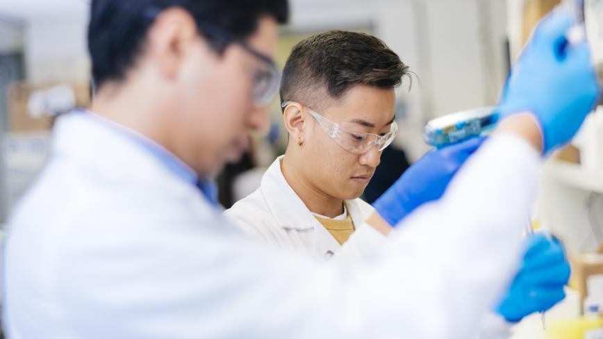 image of two researchers in lab coats in a lab