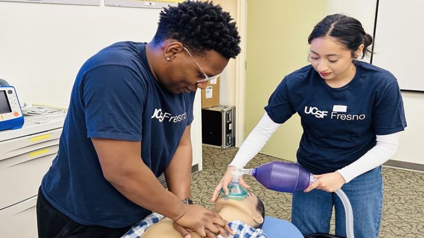 California Medicine Scholars Program/SJV MedBridge students take turns practicing CPR and rescue breathing on a simulation mannequin at UCSF Fresno