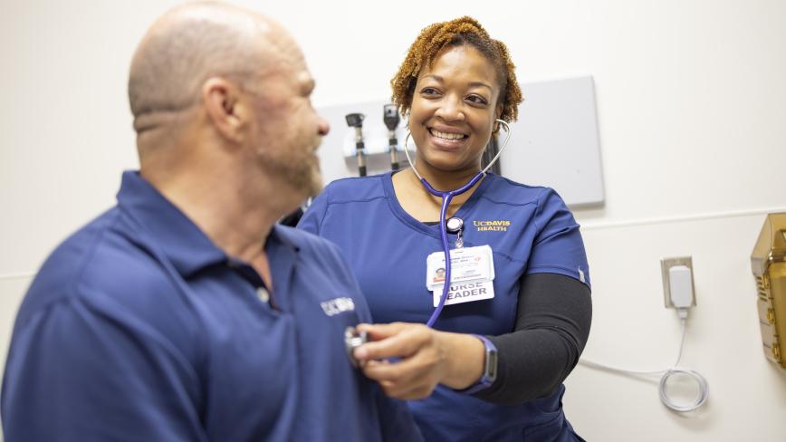 image of a health care professional using a stethoscope on a patient's heart