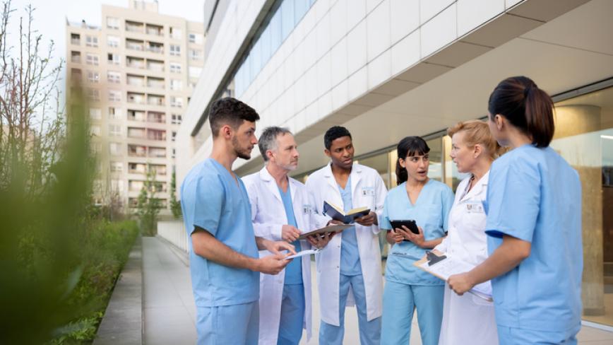 imge of a group of health care professionals speaking outside