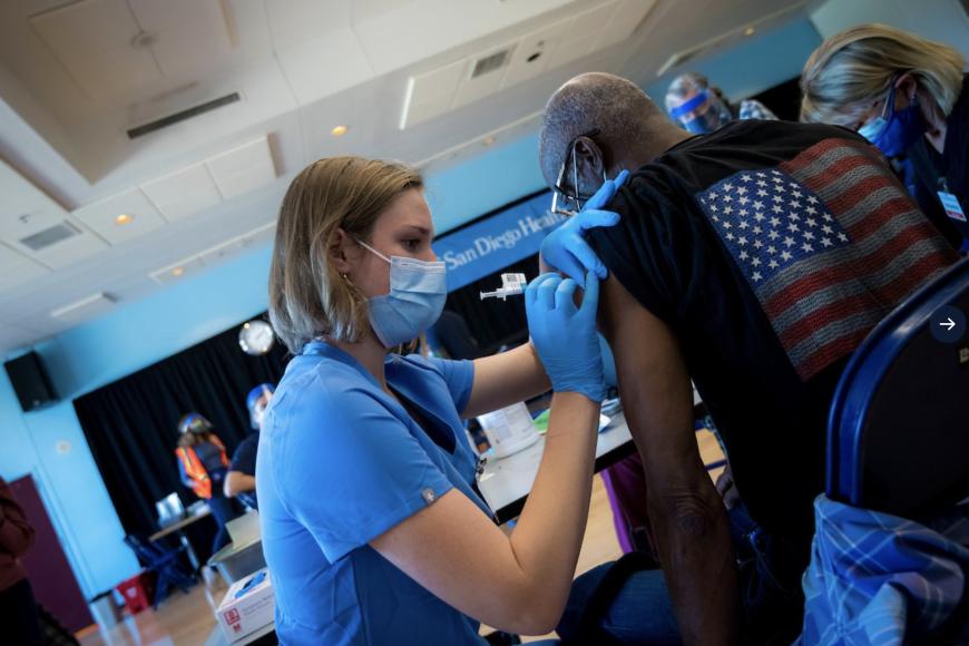 UC San Diego Health medical professional administers a COVID-19 vaccination to a community member