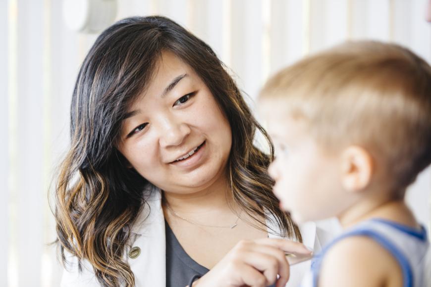 UC health family medicine clinician examining a child with a stethoscope