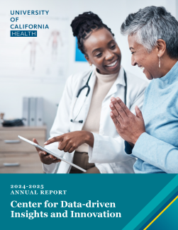 Image of a person in a white coat talking to a patient as they both look at a clipboard